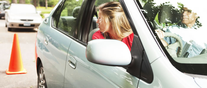 Woman looking in her rear view mirror whilst driving