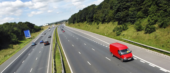 Red van driving on a motorway