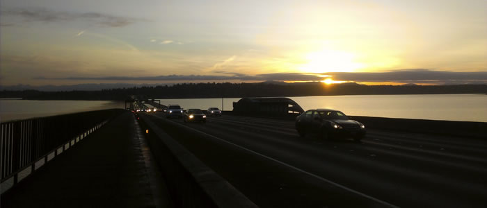 Cars crossing a bridge at night